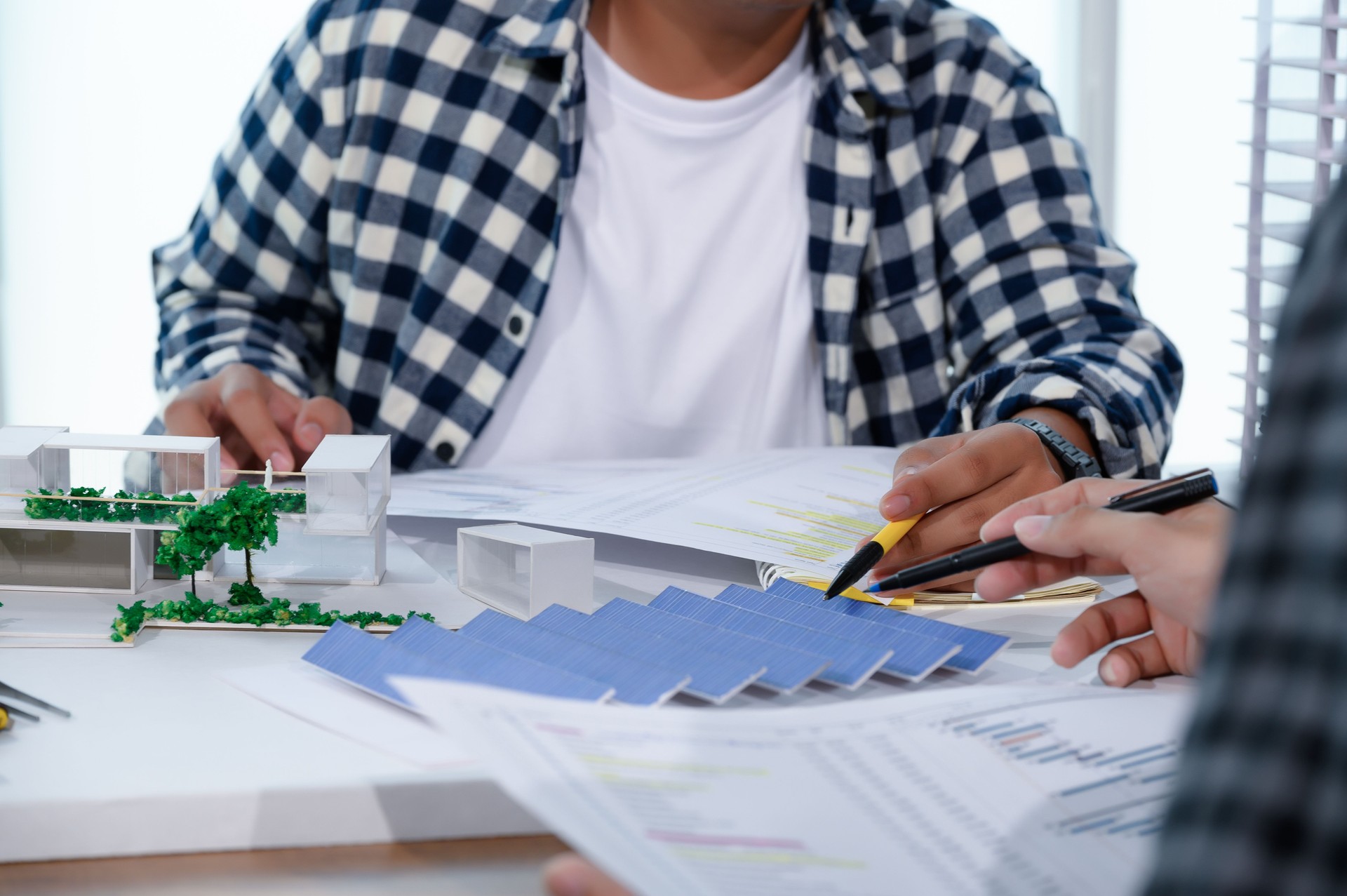 Asian Architect Students Studying Modern House Design and Finding Ways to Utilize Natural Alternative Energy or Use Natural Renewable Energy, Concepts of Eco-Friendly Living for a Sustainable Future.